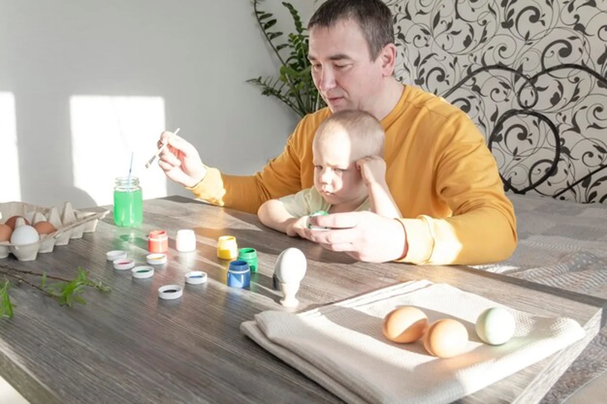 Tata i dziecko malują jajka na Wielkanoc